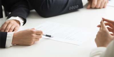 Man with pen against law document