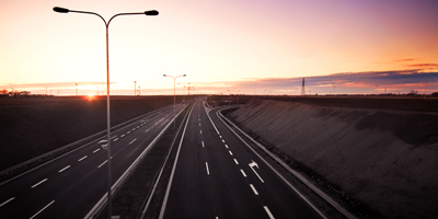 Motorway at sunset with large tall lights