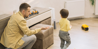 Father and back of son playing in lounge